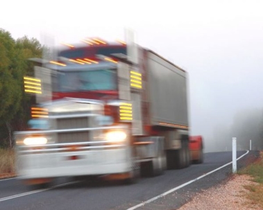 blurry image of a semi truck driving